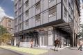 Rendering of the street level of a high rise building