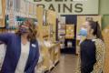 The owner of Marlene's Market and Deli speaks with an employee