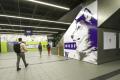 Photo of UW Huskies Wrap on the side of the escalator at University of Washington Station