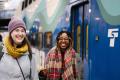 Photo of two passengers next to the Sounder Train at King Street Station