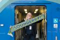 Person on train, holding Sounders scarf