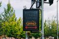 A light-up warning sign alerts passengers when a second train is coming. This "Another Train Coming" sign is a part of the safety enhancements the At-Grade Crossing Program has added near light rail.