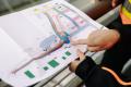 A person looks at plans for the new station in Federal Way