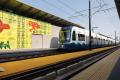 Temporary art is seen on the walls of a Link station under construction