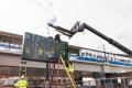 "Bitstreams - 03" is installed at Downtown Redmond Station as a Link train runs in the background.