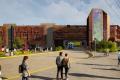 Digital rendering of the future Sumner Station parking garage. The completed multi-story facility includes architectural screening, a public art feature on the elevator tower, landscaped walkways, bus access, and pedestrians traveling between the station and the surrounding area.