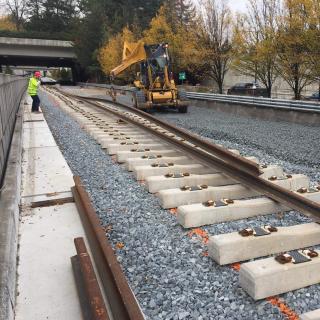 Workers installing rail on Mercer Island as part of the East Link light rail extension