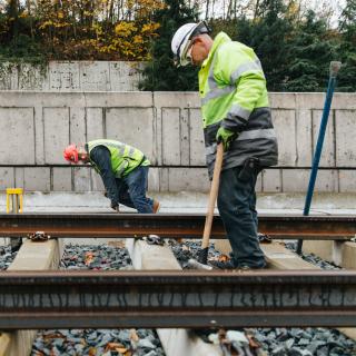 Workers installing rail on Mercer Island as part of the East Link light rail extension
