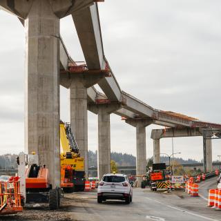 Columns and the elevated guideway rise above South Bellevue Way leading into the South Bellevue East Link light rail station.