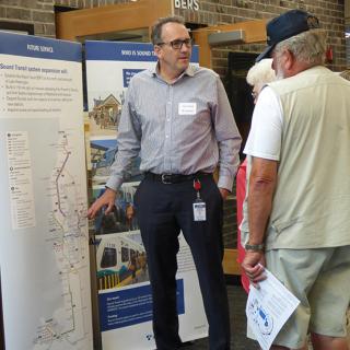 Community members discuss the I-405 BRT project with Sound Transit outreach staff.