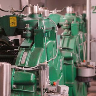 Big green pieces of equipment in an elevator control room