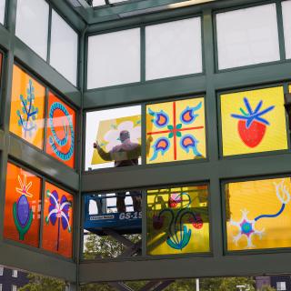 Glass pane of public art piece being installed at Auburn Sounder Station