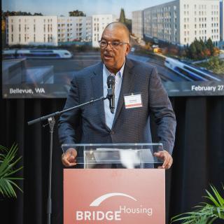 BRIDGE Housing President and CEO Ken Lombard speaks at the groundbreaking ceremony for the Spring District Station TOD.
