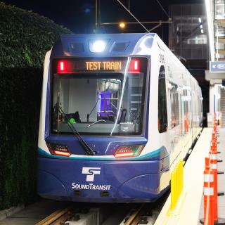 A Link vehicle parked at a platform. The head sign reads "test train."