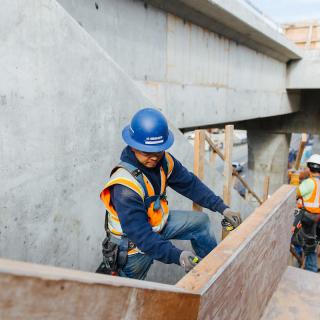 Workers build stairwells at the future Northgate Link light rail station