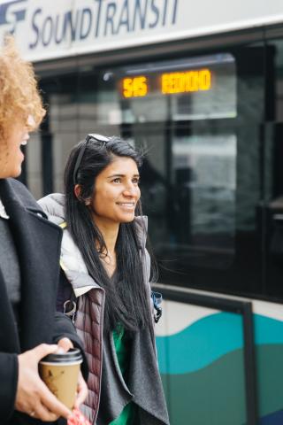 Sound transit riders walking in front of ST Express bus