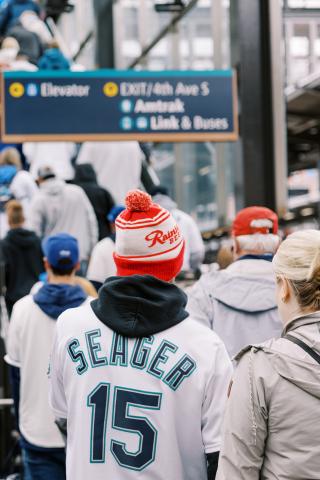 Seattle Mariners fans on a Sounder train platform.