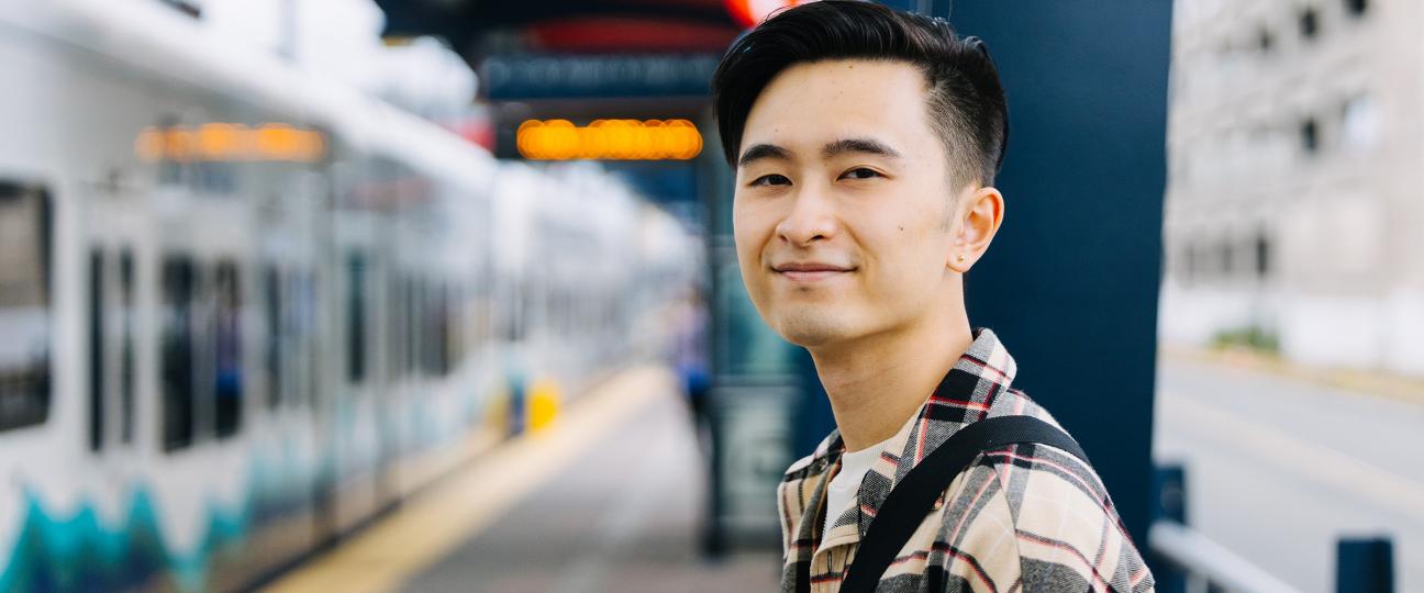 Individual passenger looks at the camera as the Link light rail arrives.