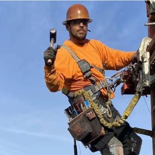A worker at a job site in Seattle with the Space Needle in the background.
