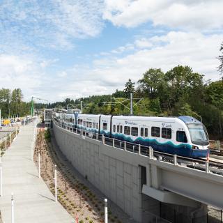 A Link light rail train travels near Star Lake Station.