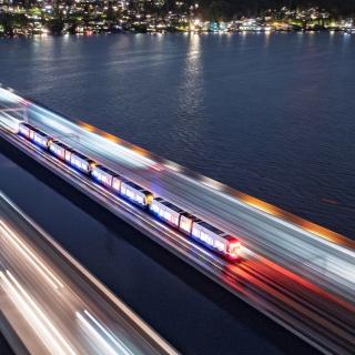 A light rail train traverses the I-90 bridge during testing.