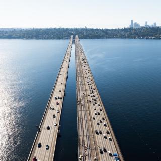 An overhead photo of the bridge across Lake Washington with both the highway and Link track in view.
