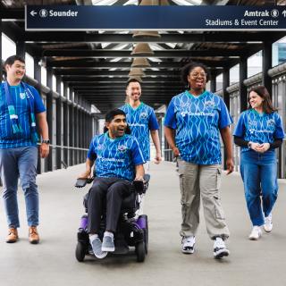 Image of passengers navigating around Seattle in soccer jerseys