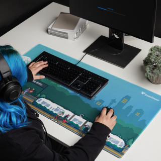 Person sitting at computer desktop with Sound Transit Shop mousepad