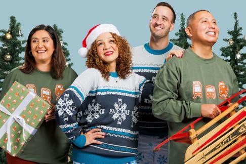 A group of four people gather wearing Sound Transit holiday gear.