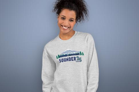 A person wearing a Sounder 25th anniversary shirt.