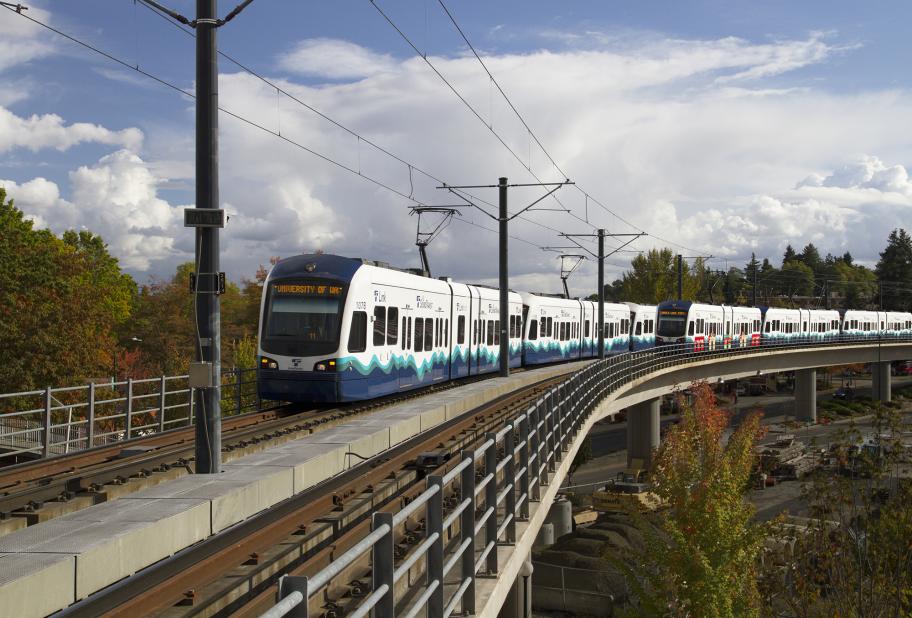 Link light rail on track with clouds in background