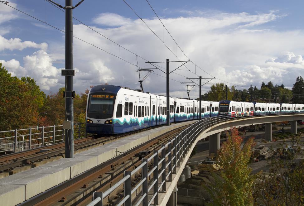 Link light rail on track with clouds in background