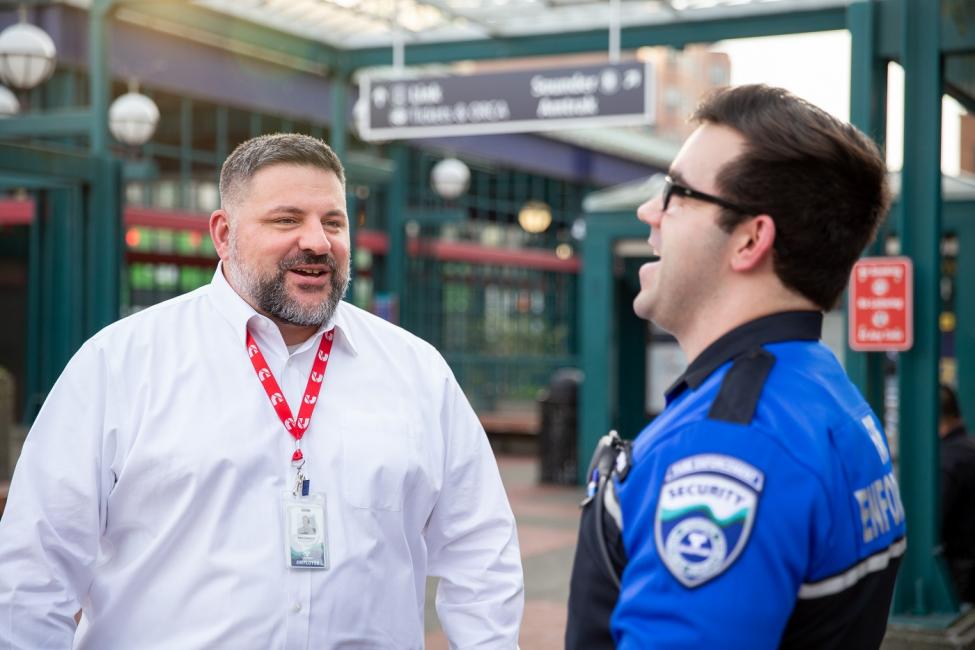 Ken Cummins, Sound Transit Director of Safety and Security jokes with a Security Officer