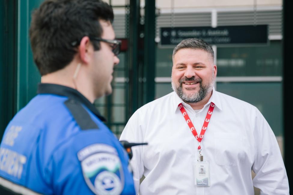 Ken Cummins, Sound Transit Director of Safety and Security jokes with a Security Officer