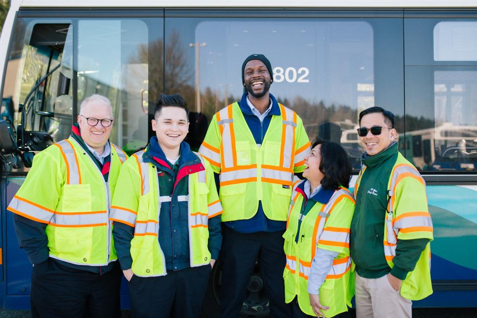 2018 in review: a group of transit drivers smiling for the camera in front of a bus.