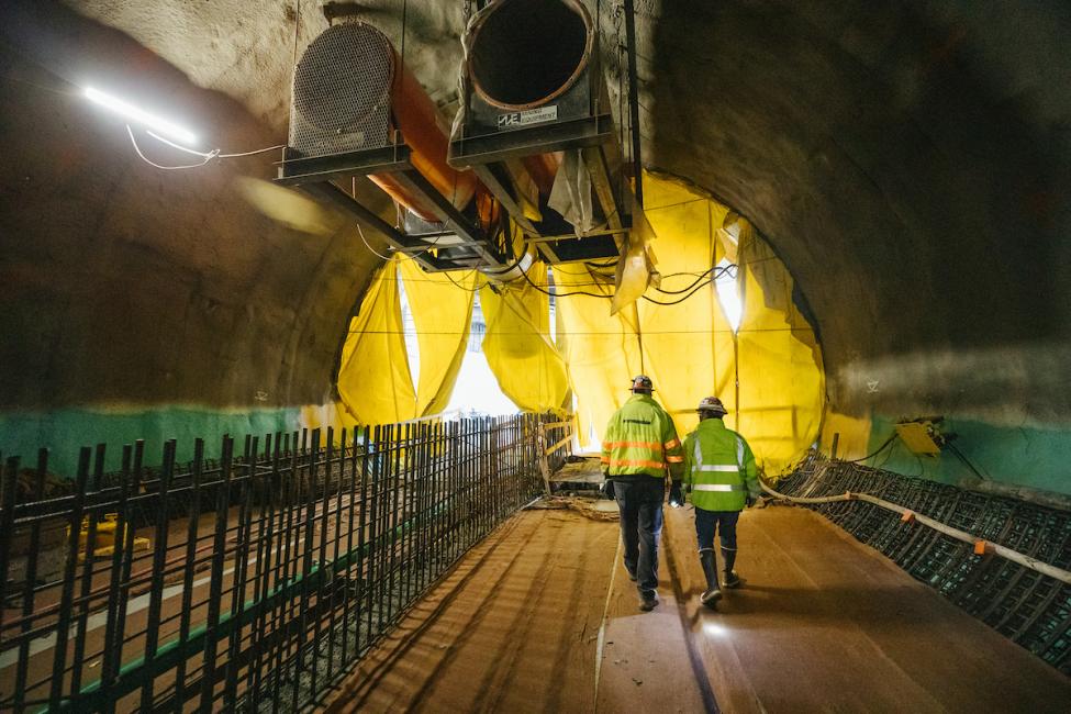 Workers approach the north portal of the future East Link light rail tunnel where trains will exit the tunnel and enter the Bellevue Downtown Station.