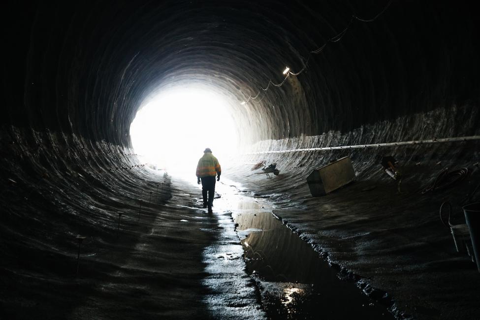 A worker heads out the south portal of the future East Link light rail tunnel under downtown Bellevue.