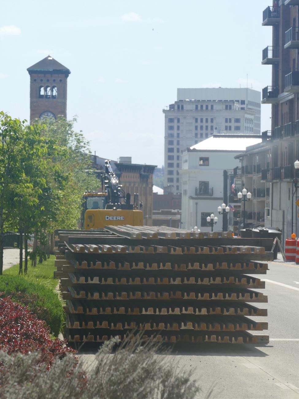 The Old City Hall is seen in the background behind a set of link rails for installation.