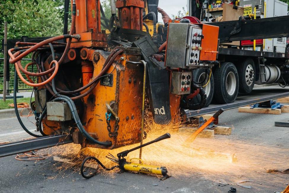 A machine grinds down the recently welded link track in Tacoma.