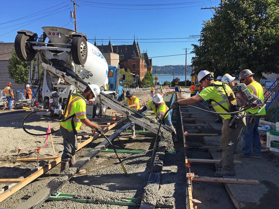 Contractors pour concrete for the track installation on North 1st Street near Stadium High School.