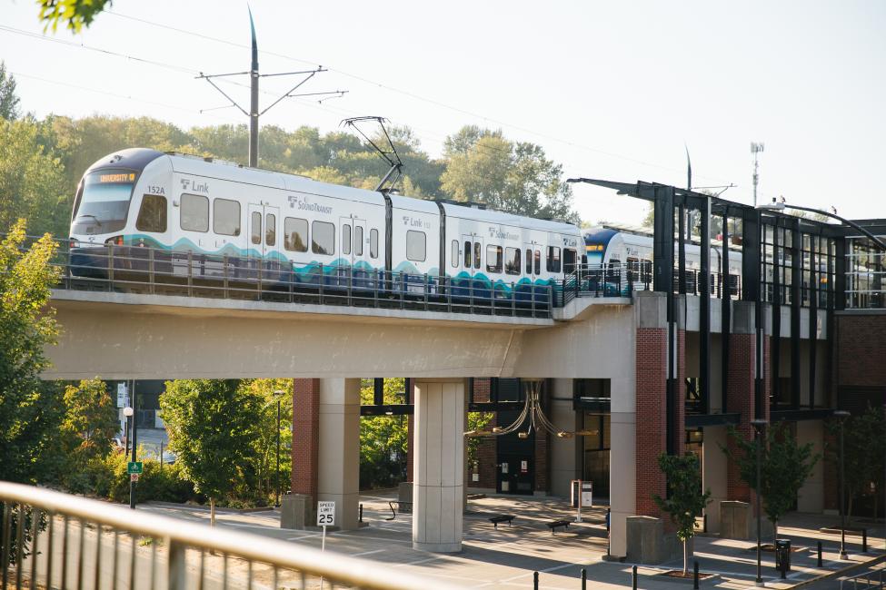 A light rail vehicle travels along a guideway.