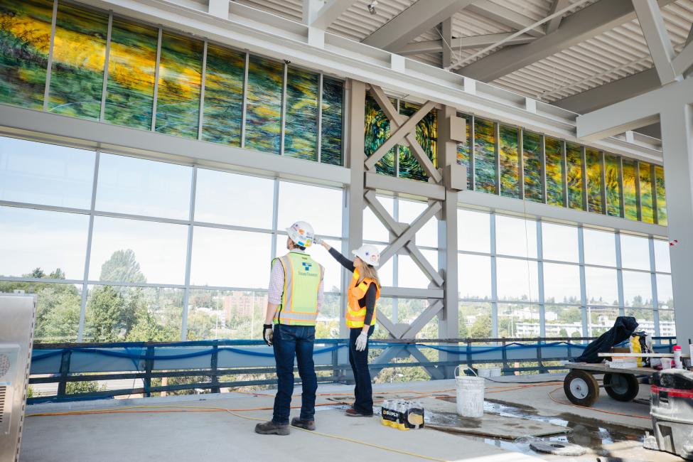 Sound Transit employees take a look at the new glass art at Northgate Station.
