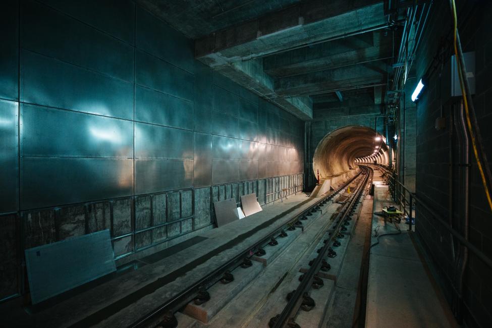 A view from the platform of one of the tunnels, bathed in blue light.