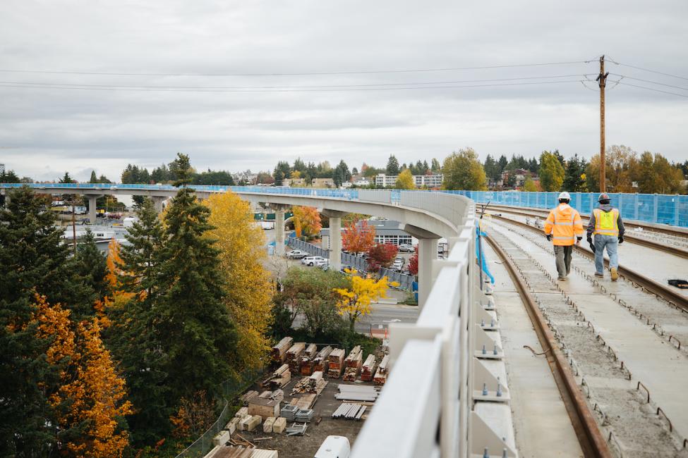 Workers walking the East Link elevated guideway leading to Wilburton Station discuss strategy for shutting down Jozy Altidore in the MLS Cup final. 