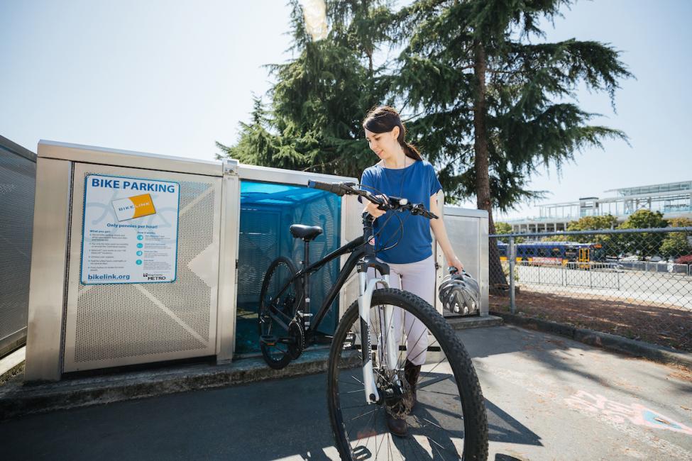 A bike rider using an on-demand smart bike locker. 