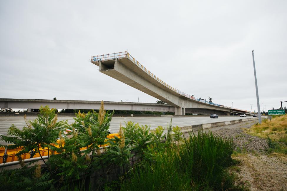 A partially constructed bridge juts out over the freeway in Bellevue.