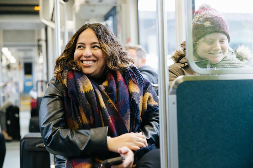 Two riders smile onboard Link light rail.