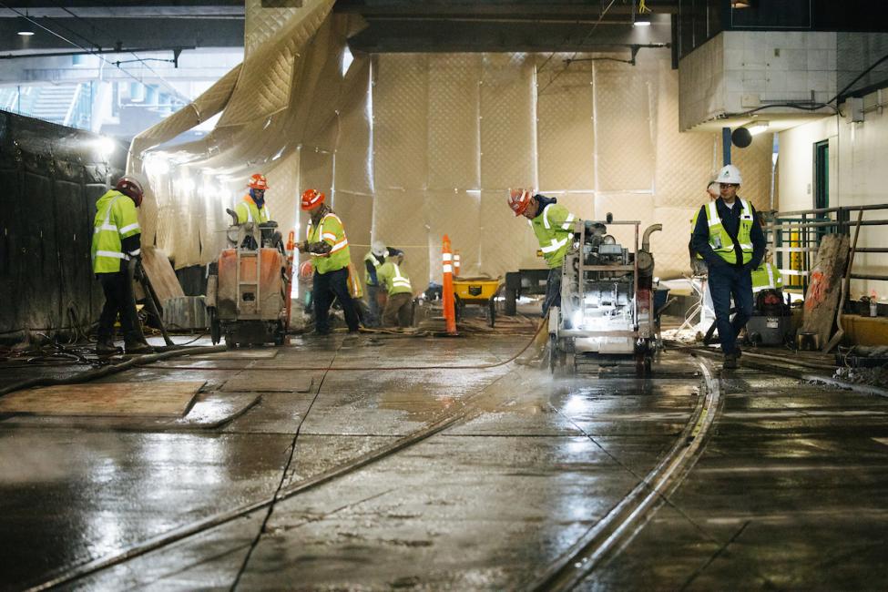 Workers in the construction area south of International District/Chinatown Station.