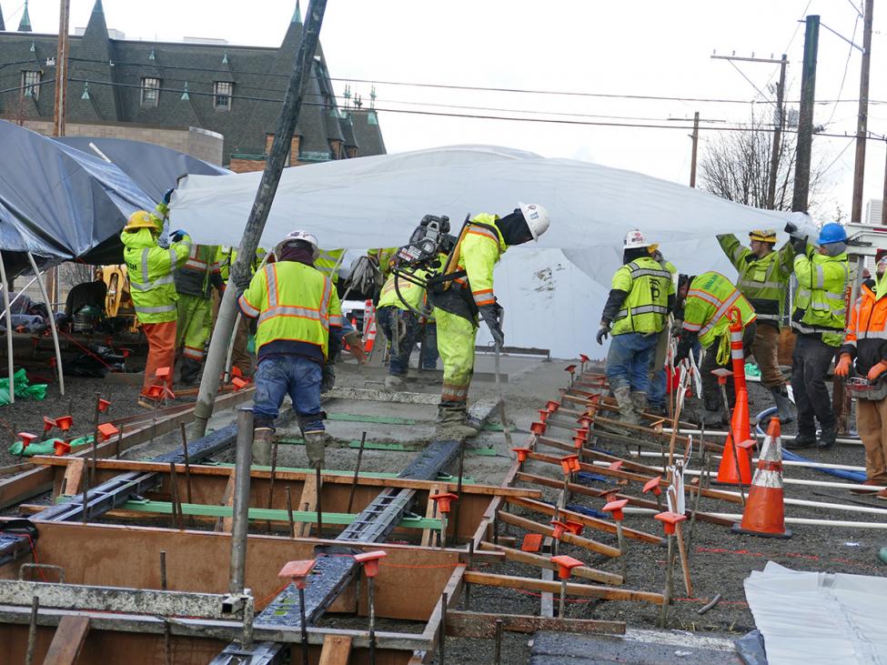 MLK Way construction concrete pouring/protecting