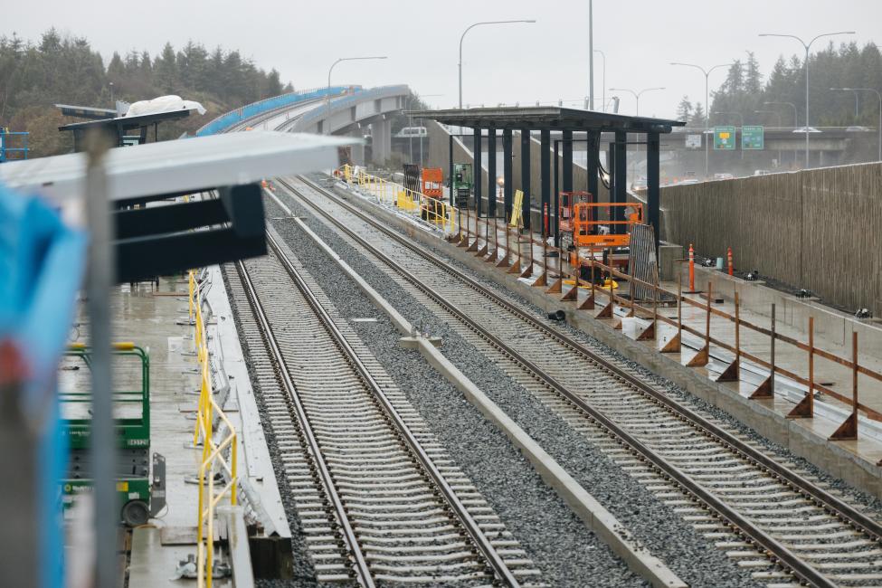 The platform and rail at Overlake Village Station, with SR-520 in the background.